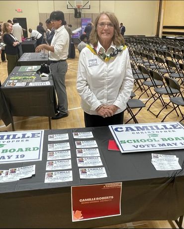 Camille Roberts promotes her school board candidacy at a community event.