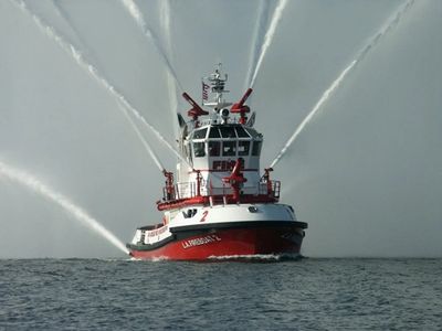 A fireboat sprays water as marine firefighting expertise is offered by PDM Consulting.