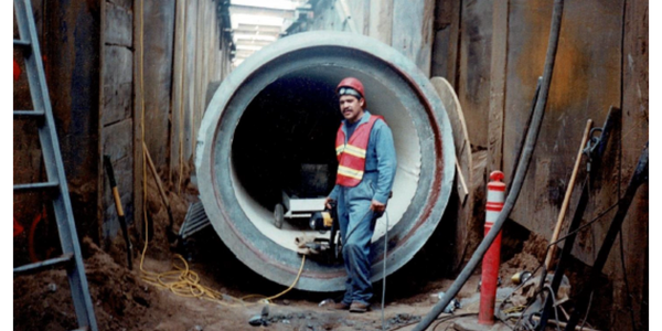Company owner working in a construction project while a picture is being taken for progress