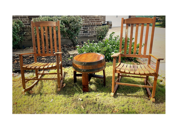 Barrel Head Side Table between two rocking chairs on grass.