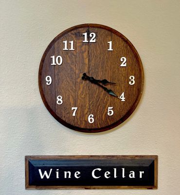 Whiskey barrel head wall clock.