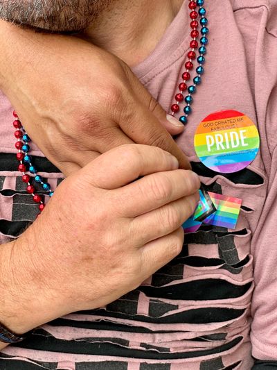 2 men holding hands at Asheville NC Pride celebration 2022.