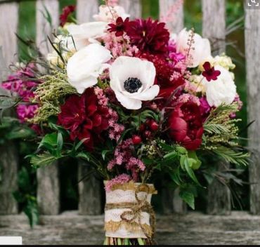 A vibrant bouquet of red, white, and pink flowers.