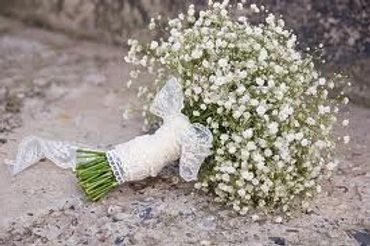 Delicate white baby's breath bouquet with lace ribbon.