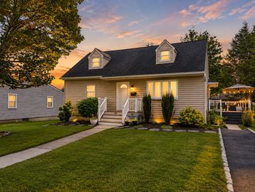 Cozy house with warm lighting at sunset.