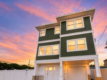 Modern three-story house at sunset.