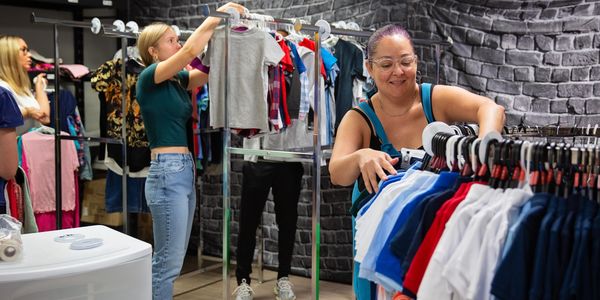 Setting up clothes on racks.