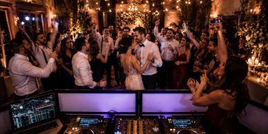 Crowd dancing joyfully at a wedding reception.