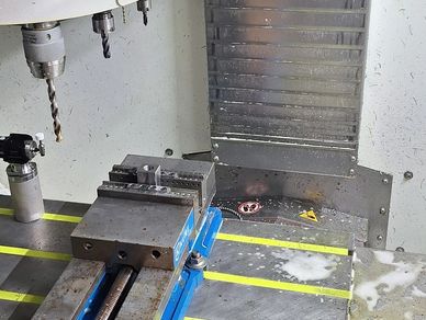 CNC milling machine with drill and vise.