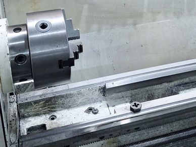 Metal lathe chuck with empty jaws.
