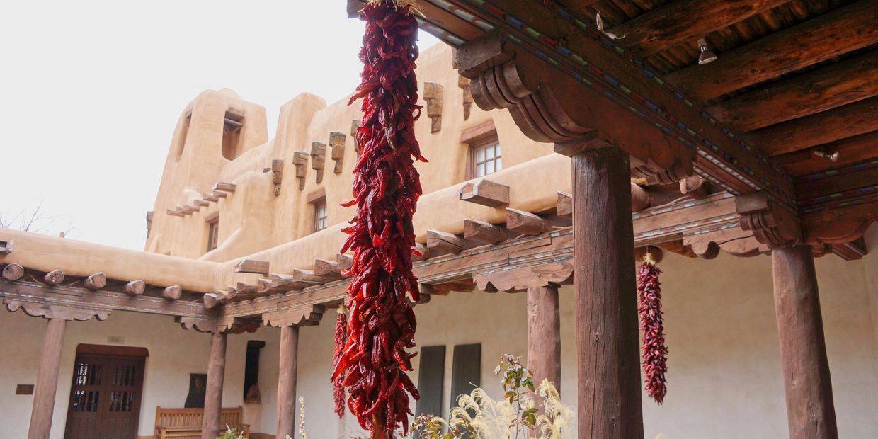Chile Ristras hanging from an adobe structure.