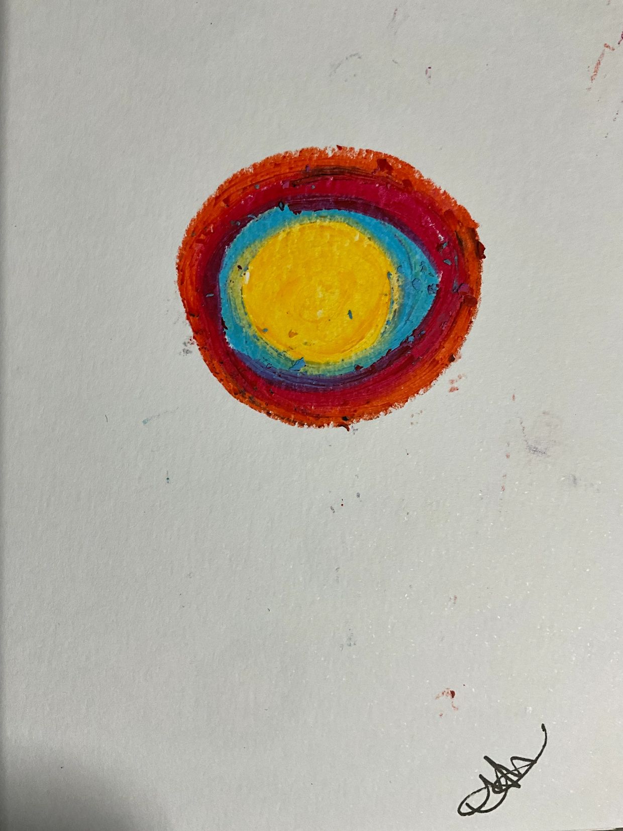 Colorful concentric circles painted on white paper.