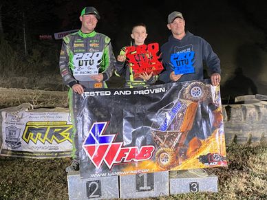 Cash is on the first place podium for the Pro Rock Racing Championship at night time