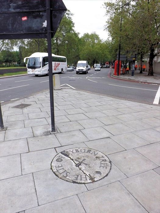 The Tyburn Tree stone memorial on the traffic island of Marble Arch
