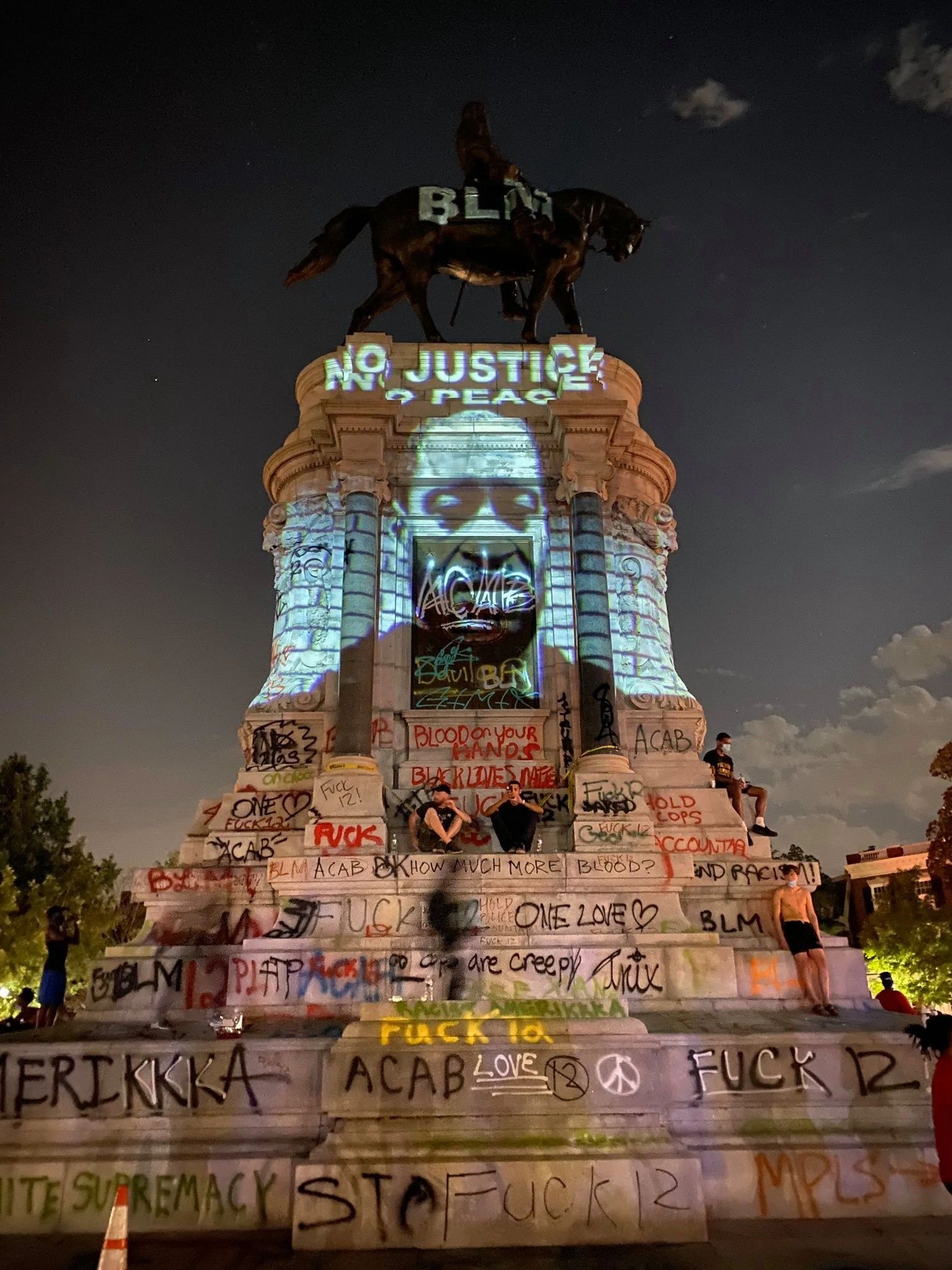 George Floyd's Image on a graffati laden Robert E. Lee statute in Richmond, Virginia