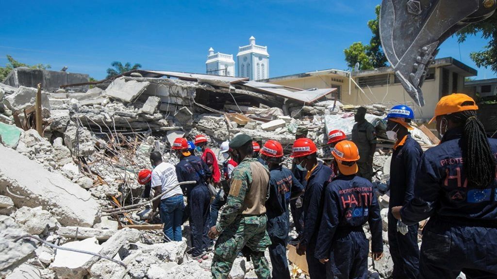 Haitian rescue workers comb through the rubble in the aftermath of the Haitian Earthquake.