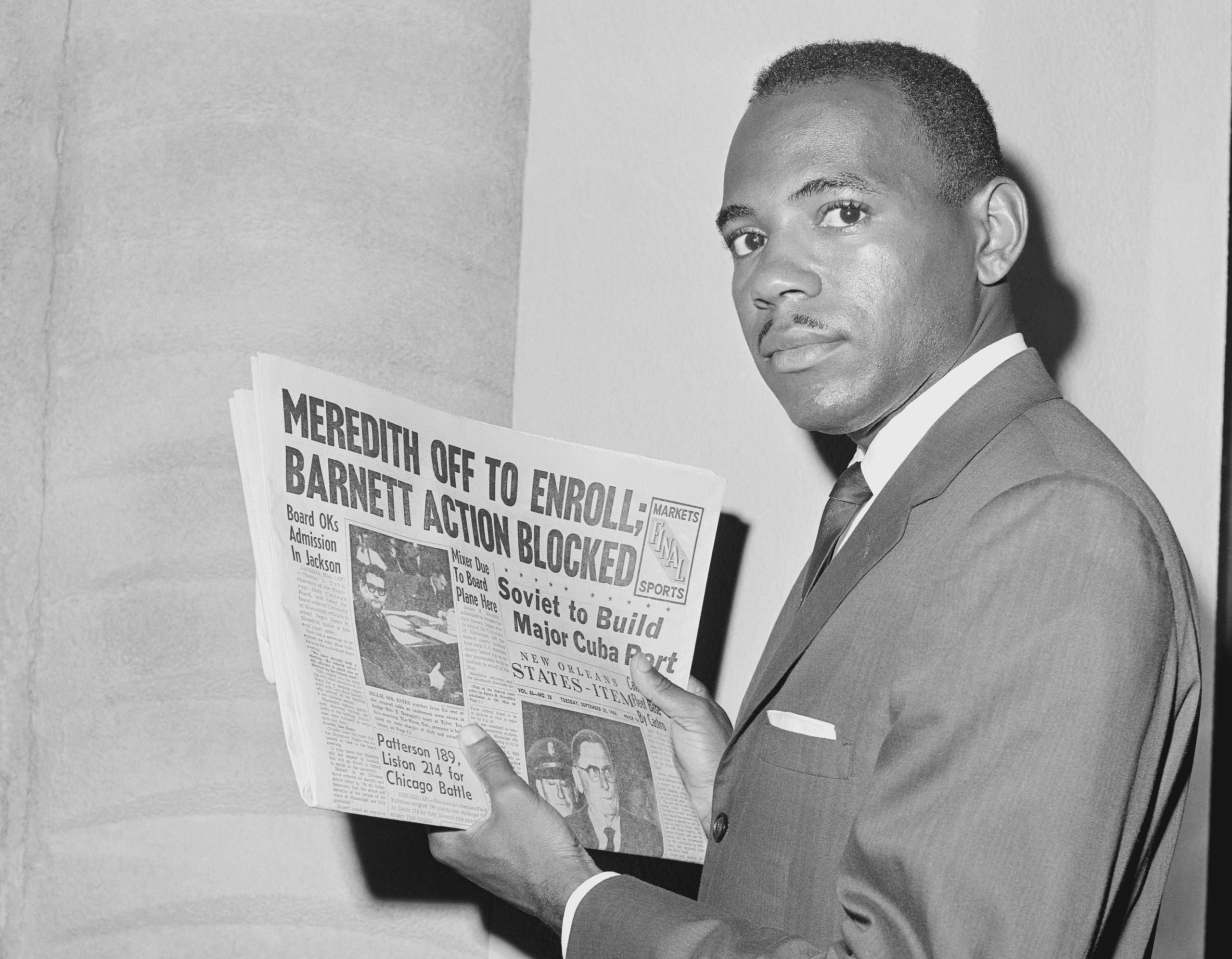 James Meredith holding newspaper describing his efforts to desegregatwe the University of Mississippi in 1962