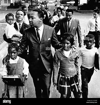 Martin Luther King, Ralph Abernathy and Andrew Young escorting children to school in Grenada, Mississippi in 1966