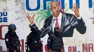 Haitian Security forces during "state of siege in Port-au-Prince under campaign mural for former president Moise.