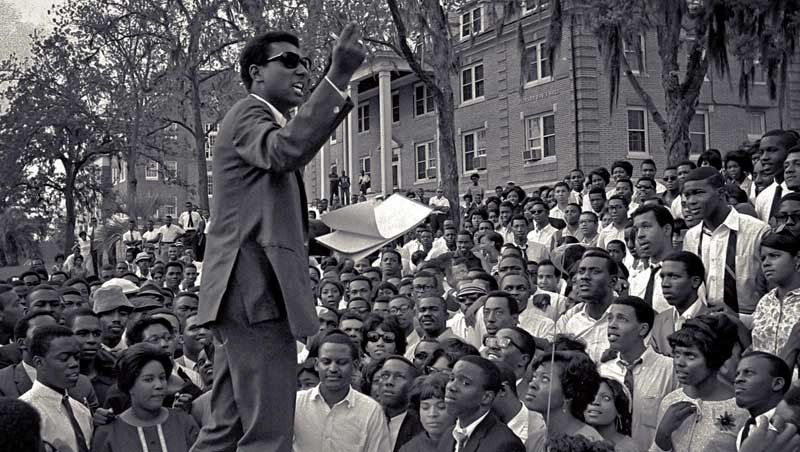 Stokely Carmichael, Chairman of SNCC, talking from the hood of a car on the campus of Florida A&M in 1967.