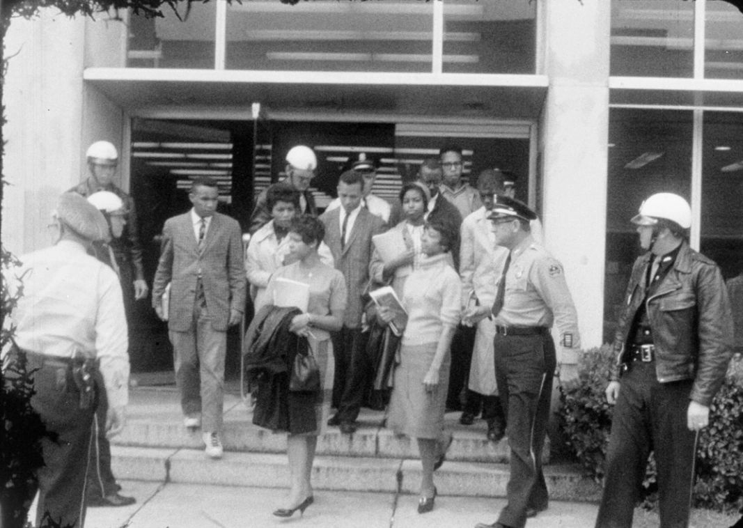 Tougaloo Nine escorted from Jackson Municipal Library , 1961