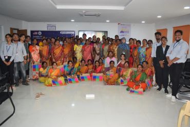 Large group photo in a conference or seminar setting.