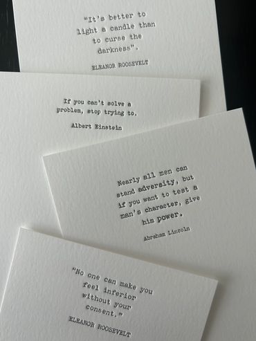 Inspirational quotes typed on white cards.