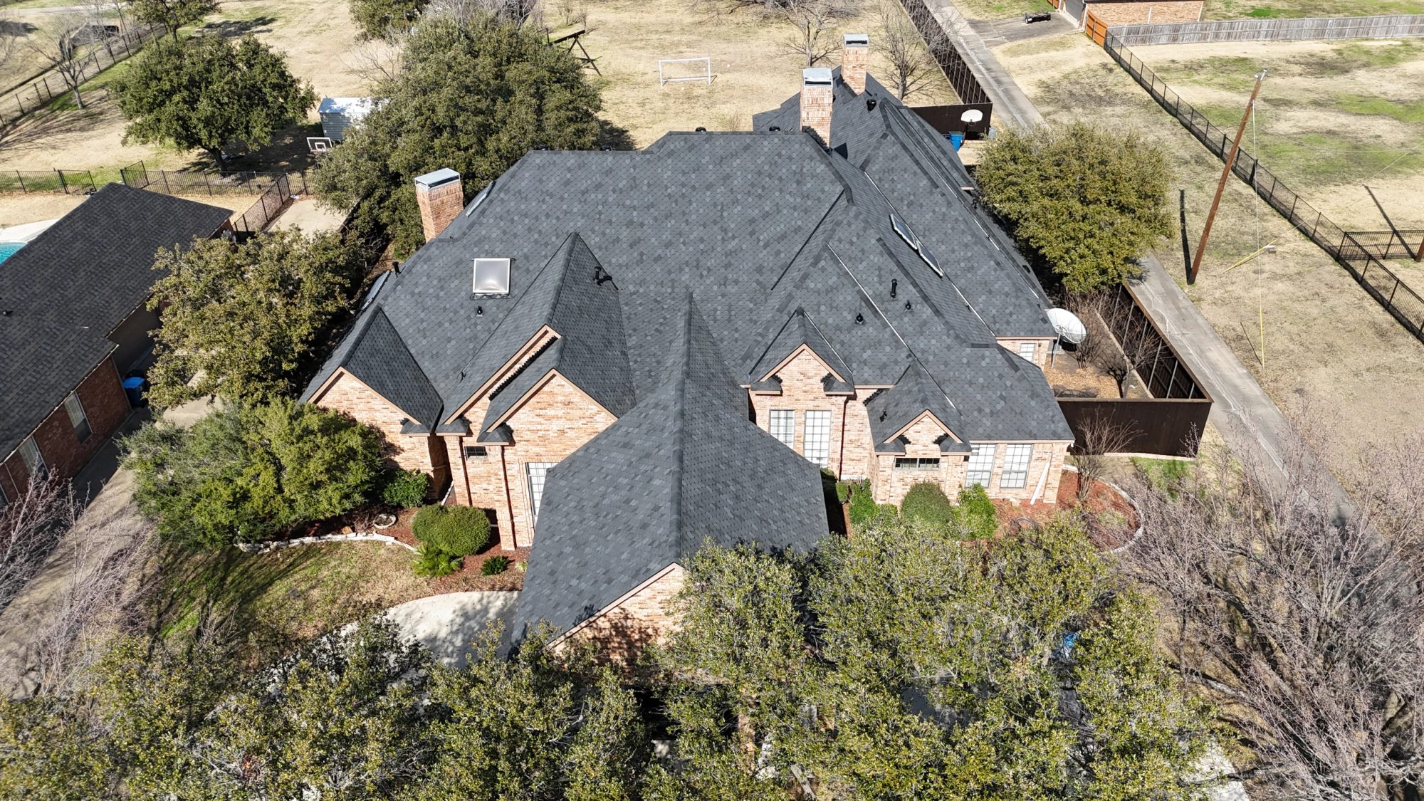 Completed architectural shingle roof replacement on a North Texas home
