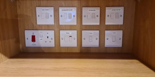 Panel of override swithces to control appliances in a kitchn.