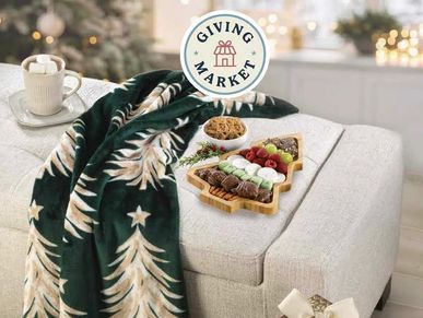 Festive holiday blanket with a Christmas tree pattern on a cozy couch.