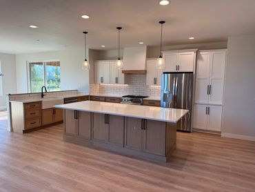 Modern kitchen with a large island and pendant lights.