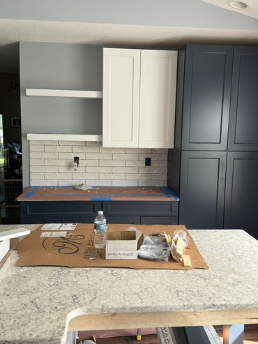 Kitchen under renovation with new cabinets and countertop.
