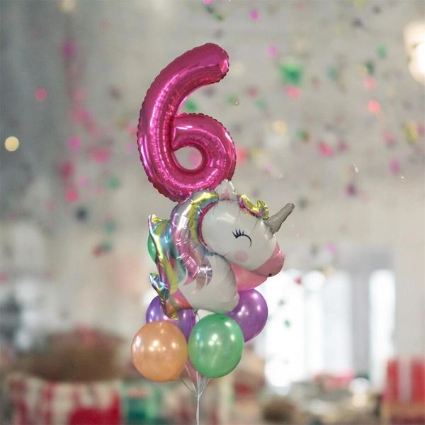 Colorful birthday balloons with a large pink number 6 and a unicorn.