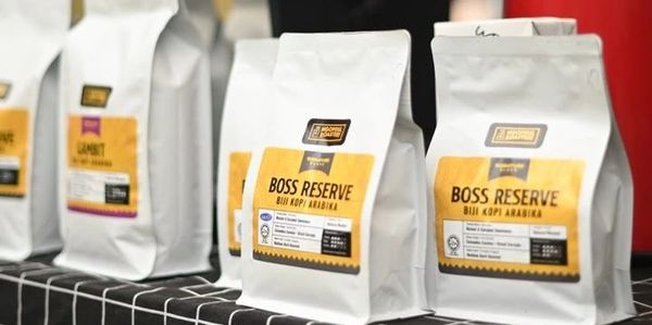 Rows of Boss Reserve coffee bags neatly displayed on a table.