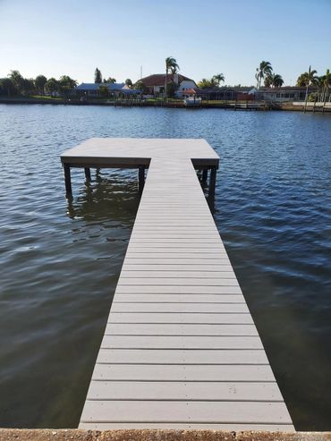 simple tan dock leading to waterway