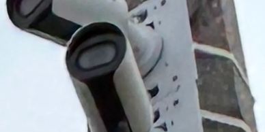 Two security cameras mounted on a pole.