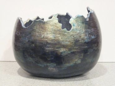 Carved round gourd depicting ocean waves