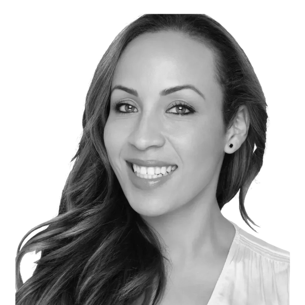 Smiling woman with long hair and earrings.