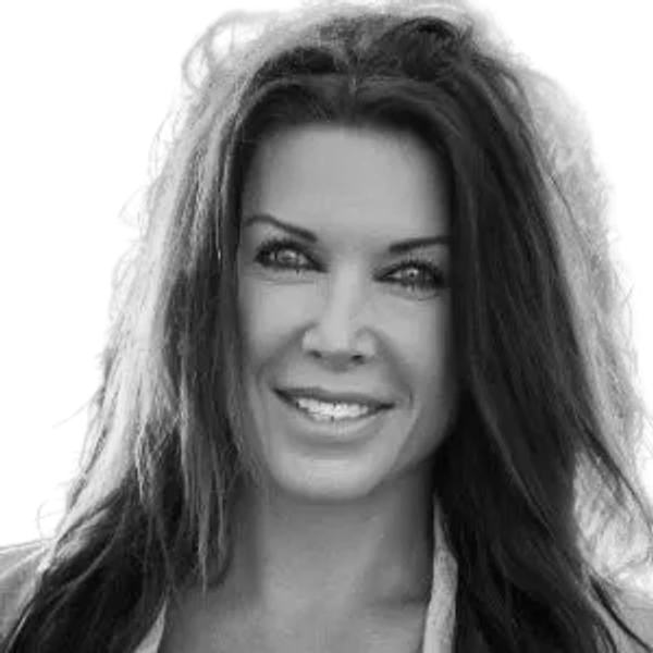 Smiling woman with long hair in black and white photo.