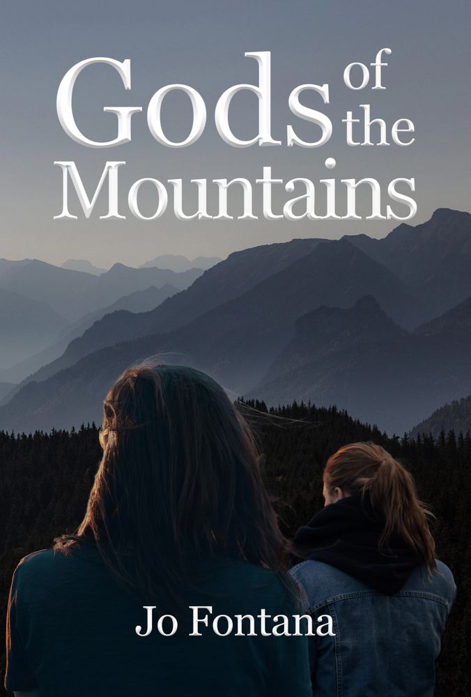 Mother and daughter gazing at foggy mountains. 