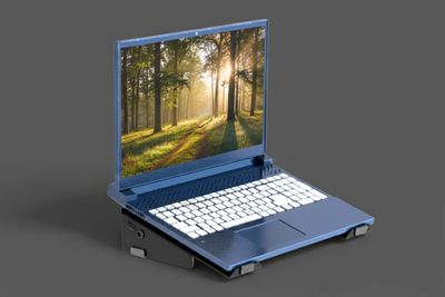 Blue laptop with a nature scene on the screen.