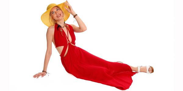 A woman wears a red long dress made of organic cotton fabric
