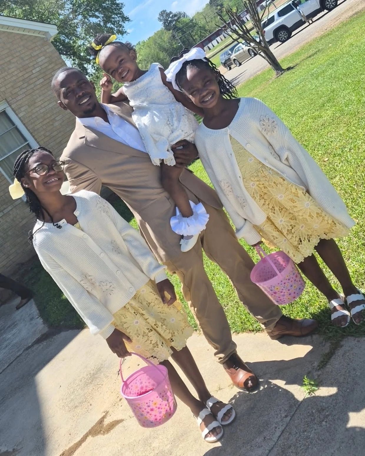 A father taking a picture with his family.