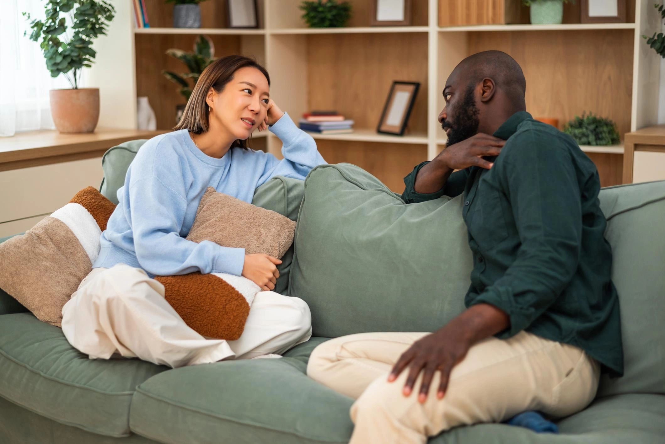 Two people having a deep conversation on a couch.