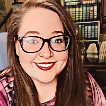 Smiling woman with glasses in a cozy home library.