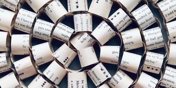 a paper chain made from book pages coiled up to form a sprial