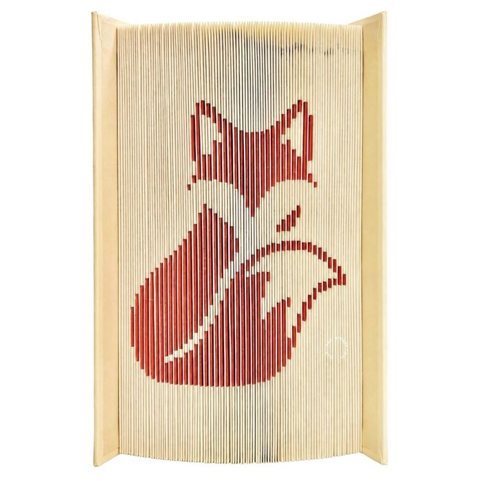 Book art piece with an orange fox folded into the pages against a white background