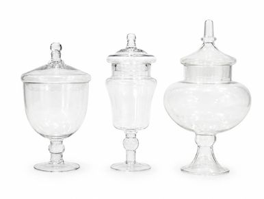 Three clear glass apothecary jars with lids.