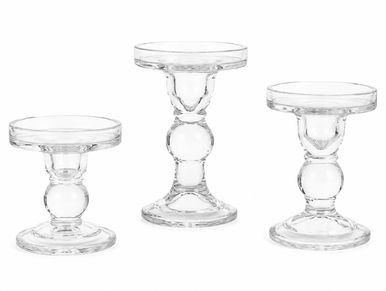 Set of three clear glass candle holders of different heights.