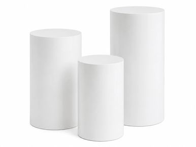 Three white cylindrical pedestals of varying heights.